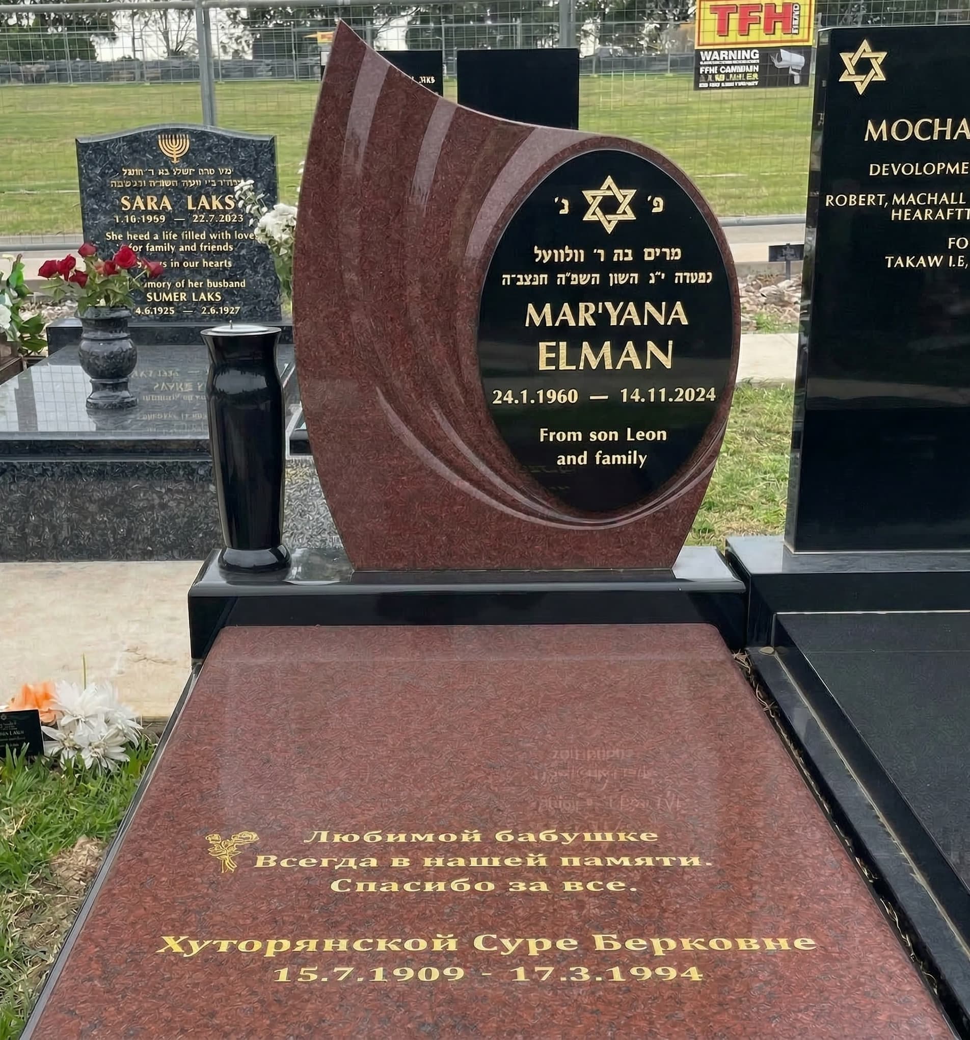 Single full Jewish monument with a tear shaped headstone, gold leaf lettering, and ruby red and jet black granite.