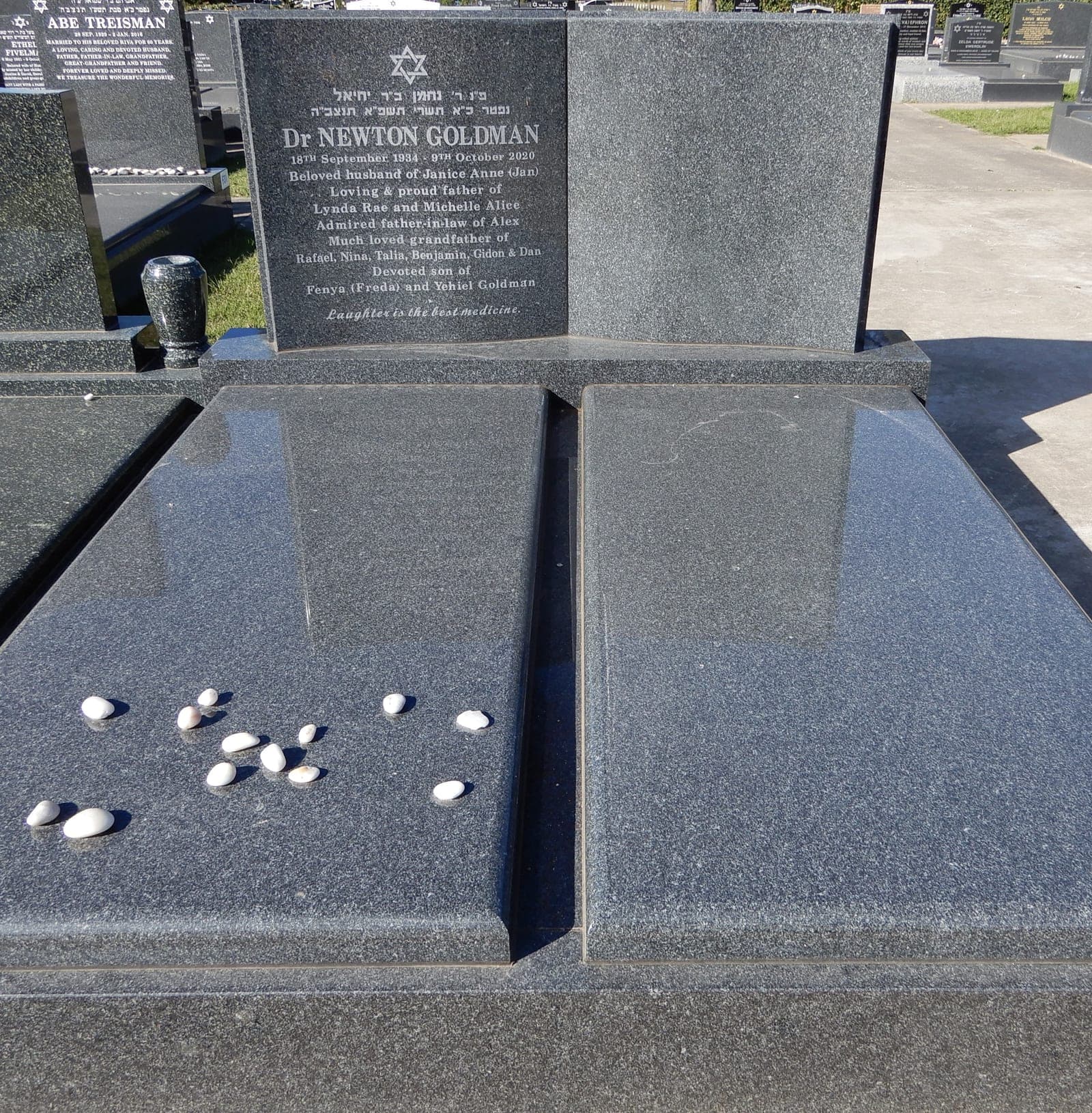 Double full Jewish gravestone with a book-shaped headstone, natural cut-in lettering, and noble grey granite.